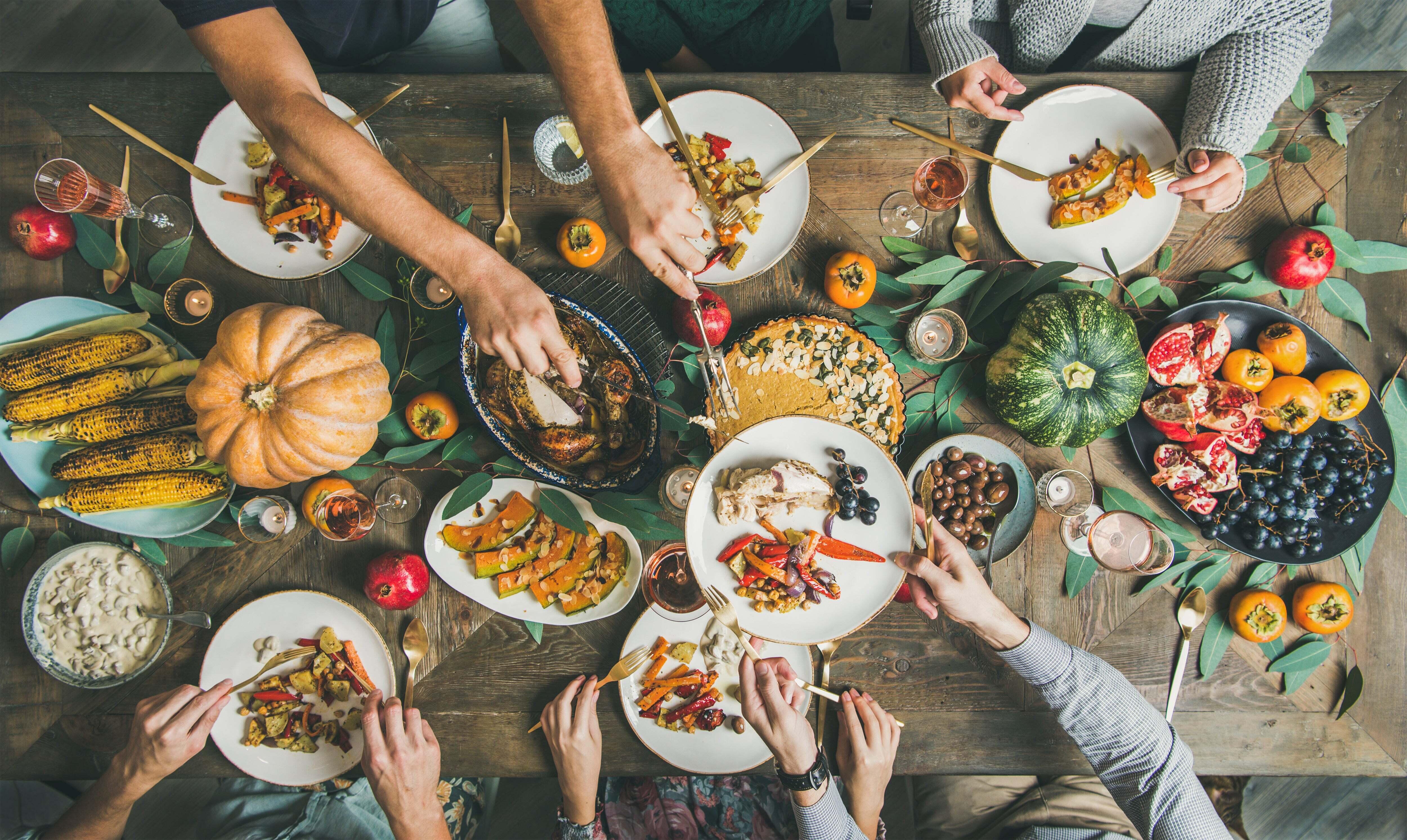 A large table full of Thanksgiving food