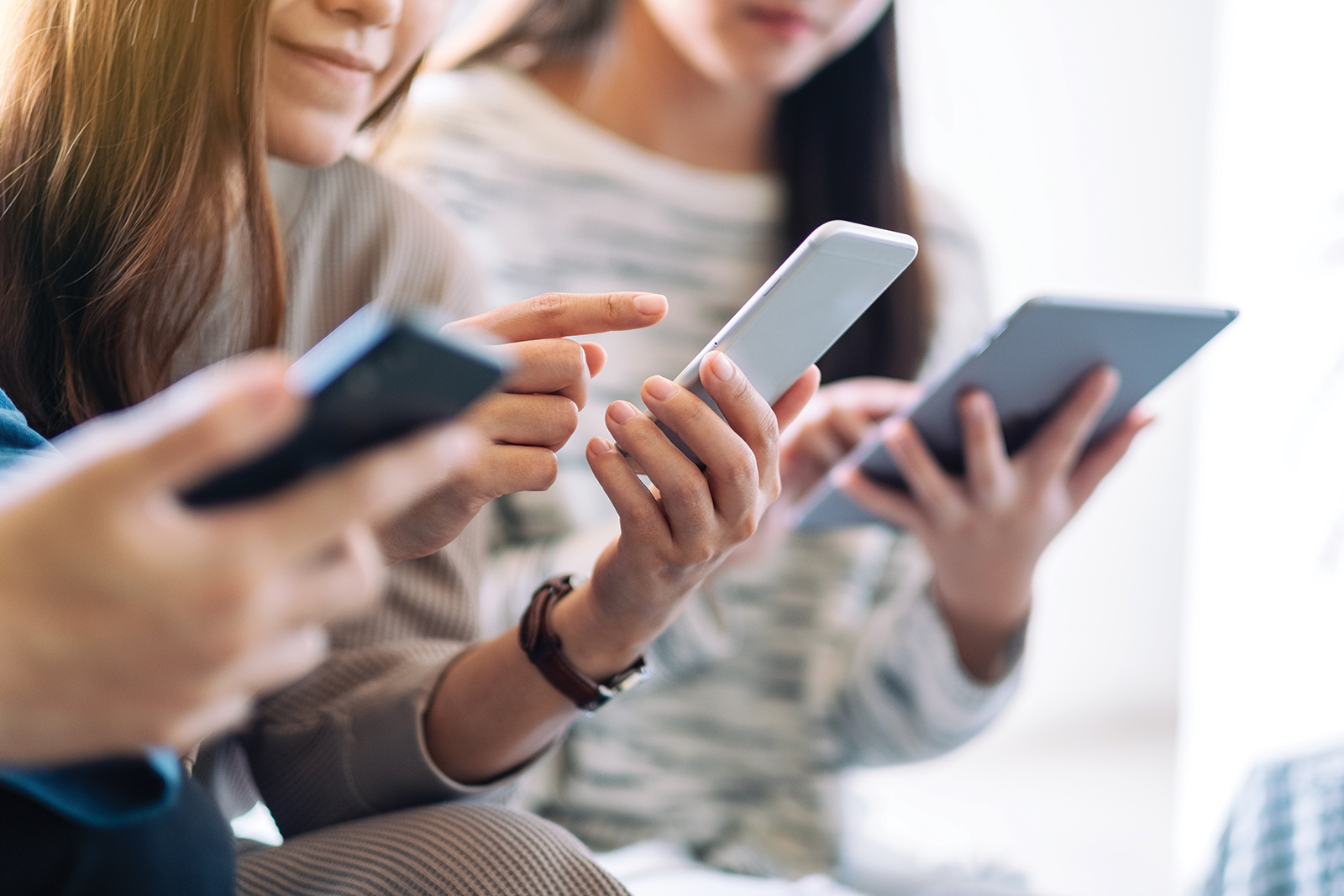 Customers viewing smartphones in their hands