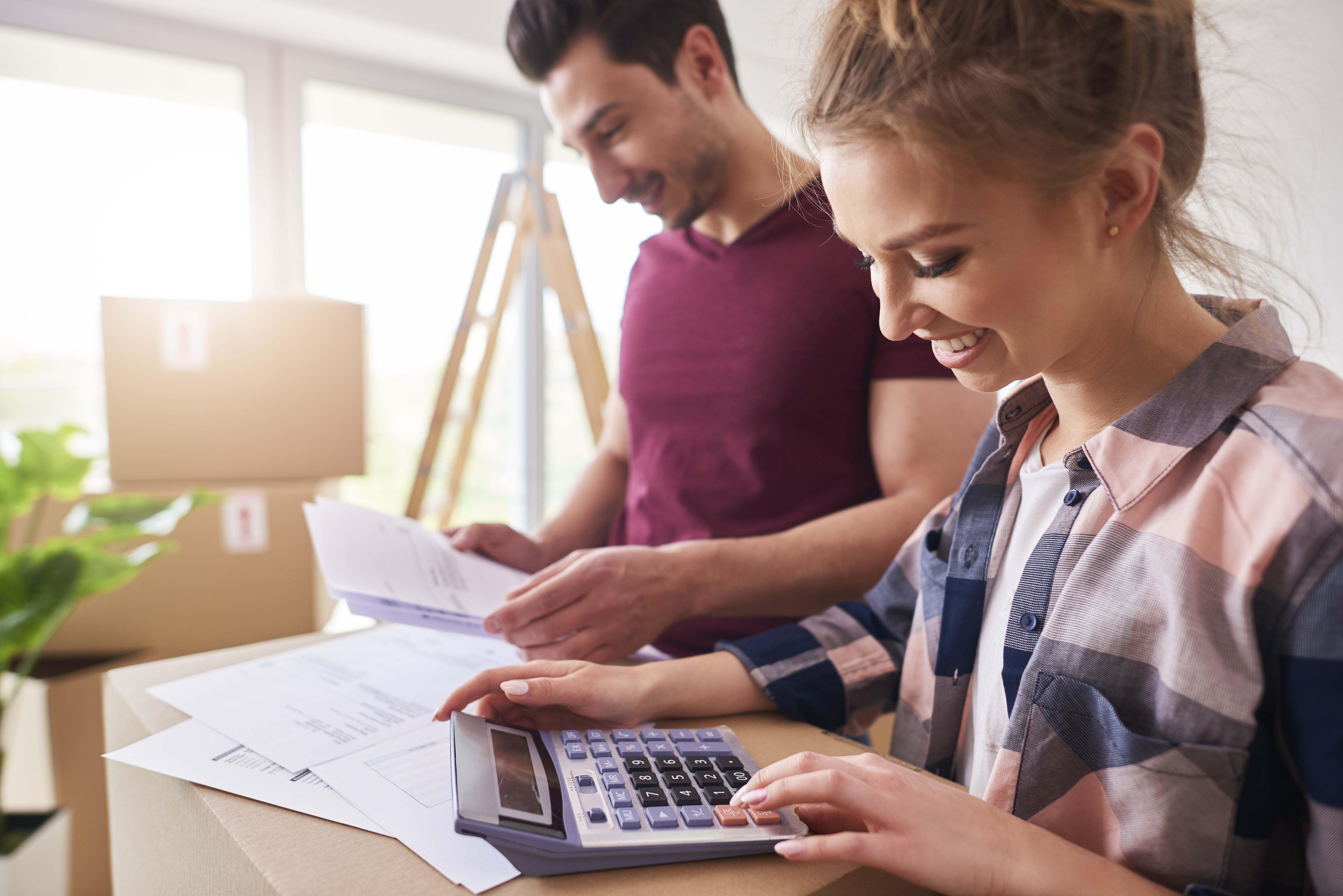 A couple going over their finances with a calculator