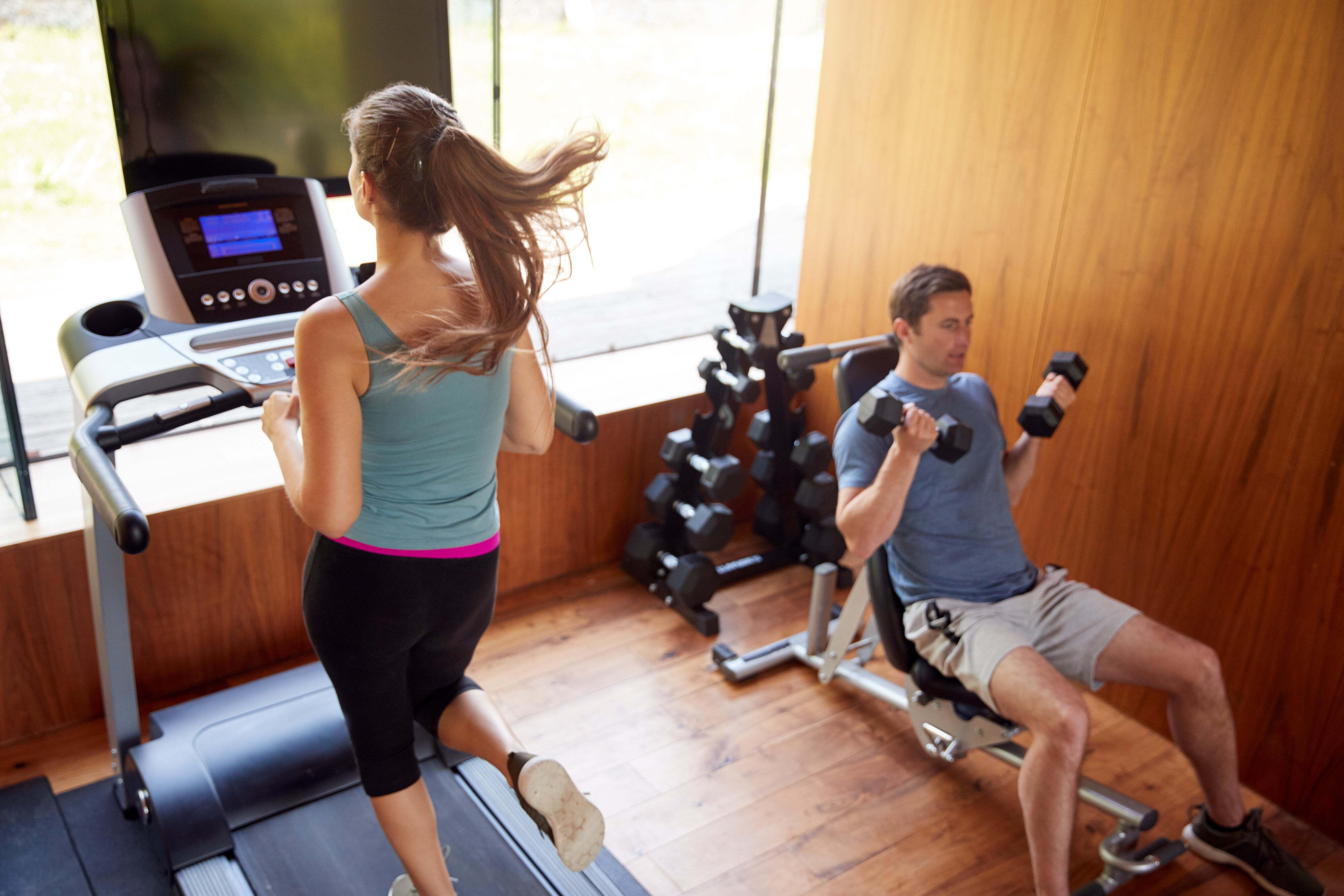 A man and woman working out in a gym